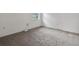 Neutral carpeted bedroom featuring white walls and natural light from a window at 4246 Ne 32Nd Cir, Ocala, FL 34479