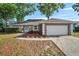 Beautiful one-story home with a well-manicured lawn and a two-car garage at 4246 Ne 32Nd Cir, Ocala, FL 34479