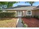 Inviting front door with decorative glass and manicured landscaping at 4246 Ne 32Nd Cir, Ocala, FL 34479