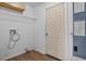 Functional laundry room with overhead storage and connections for washer and dryer at 4246 Ne 32Nd Cir, Ocala, FL 34479