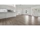Sun-filled living room open to the kitchen with modern flooring and white walls at 4246 Ne 32Nd Cir, Ocala, FL 34479