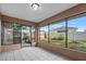 Screened in back porch featuring tiled floors, a view of the backyard, and access to the patio at 4246 Ne 32Nd Cir, Ocala, FL 34479