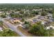 Wide aerial shot reveals a residential area with numerous houses, tree-filled yards, and quiet streets at 44 Pecan Run Dr, Ocala, FL 34472