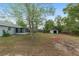 Expansive backyard featuring a screened patio and storage shed, perfect for outdoor activities and storage at 44 Pecan Run Dr, Ocala, FL 34472