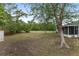 A large backyard featuring a storage shed and screened patio, providing plenty of space for outdoor activities at 44 Pecan Run Dr, Ocala, FL 34472