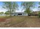 Backyard with screened patio offers views of lush greenery and mature trees, creating a tranquil outdoor space at 44 Pecan Run Dr, Ocala, FL 34472