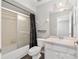 Bright bathroom featuring a shower-tub combo, vanity, and a decorative black shower curtain at 44 Pecan Run Dr, Ocala, FL 34472