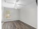 Bedroom with hardwood floors, a ceiling fan, and a window at 44 Pecan Run Dr, Ocala, FL 34472
