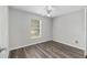 Bedroom with hardwood floors, a ceiling fan, and a window at 44 Pecan Run Dr, Ocala, FL 34472