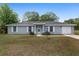 Charming single-story home with a well-manicured lawn and attached garage at 44 Pecan Run Dr, Ocala, FL 34472