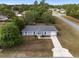 Charming one-story home with a gray roof, white trim, and a well-manicured front lawn at 44 Pecan Run Dr, Ocala, FL 34472