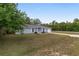 Charming one-story home with manicured front lawn and attached garage at 44 Pecan Run Dr, Ocala, FL 34472