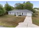 Picture-perfect single-story home featuring a gray roof, clean lines, and a welcoming entrance at 44 Pecan Run Dr, Ocala, FL 34472