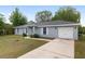 Charming single-Gathering home with a well-manicured front yard and an attached garage at 44 Pecan Run Dr, Ocala, FL 34472