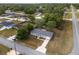Aerial view of a cozy single-Gathering home with a gray roof and a well-maintained lawn at 44 Pecan Run Dr, Ocala, FL 34472