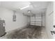 Spacious garage with garage door, water heater, concrete floor, and electrical panel at 44 Pecan Run Dr, Ocala, FL 34472