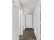 Hallway with dark plank floors leading to multiple rooms at 44 Pecan Run Dr, Ocala, FL 34472