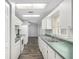 Kitchen featuring a double sink, white appliances, and green countertops at 44 Pecan Run Dr, Ocala, FL 34472