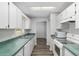 Bright kitchen featuring white cabinetry, green countertops, and stainless steel sink at 44 Pecan Run Dr, Ocala, FL 34472
