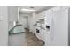 The kitchen features white appliances and cabinetry and green countertops at 44 Pecan Run Dr, Ocala, FL 34472