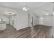 Open-concept living room with gray walls, wood flooring, and modern lighting at 44 Pecan Run Dr, Ocala, FL 34472