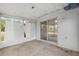 A cozy enclosed patio featuring sliding glass doors and durable flooring, perfect for relaxing or entertaining guests at 44 Pecan Run Dr, Ocala, FL 34472