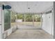 Enclosed screened-in porch with a view of the backyard and a storage shed at 44 Pecan Run Dr, Ocala, FL 34472