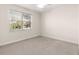 Bedroom with light-filled window and neutral carpeting for a bright, airy feel at 4780 Sw 103Rd Street Rd, Ocala, FL 34476