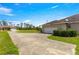 Long driveway leading to a garage, surrounded by lush greenery at 4780 Sw 103Rd Street Rd, Ocala, FL 34476