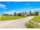 Property features a long driveway and a spacious front yard with mature trees at 4780 Sw 103Rd Street Rd, Ocala, FL 34476