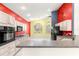 Modern kitchen with white cabinets, granite countertops, stainless appliances, and colorful walls at 4780 Sw 103Rd Street Rd, Ocala, FL 34476