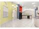 Bright kitchen with white cabinets, black appliances, tile flooring, and modern lighting at 4780 Sw 103Rd Street Rd, Ocala, FL 34476