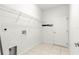 Efficient laundry area with tile floor and shelving for organizing at 4780 Sw 103Rd Street Rd, Ocala, FL 34476