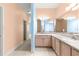 Main bathroom featuring dual sinks with a large framed mirror, tile floors, and neutral walls at 4780 Sw 103Rd Street Rd, Ocala, FL 34476