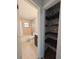 View from a hallway into a bathroom with tile flooring and shelves at 4785 Ne 28Th Ter, Ocala, FL 34479