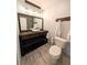 Bathroom with rustic wood vanity, hanging lights, and modern fixtures at 4785 Ne 28Th Ter, Ocala, FL 34479