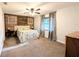 Cozy bedroom with ceiling fan, carpeted floors, and a decorative wood accent wall at 4785 Ne 28Th Ter, Ocala, FL 34479