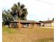 Charming single story brick home with a well-maintained lawn and a bright blue front door at 4785 Ne 28Th Ter, Ocala, FL 34479