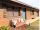 Close-up of inviting front porch with a cozy swing, accented by colorful pillows at 4785 Ne 28Th Ter, Ocala, FL 34479