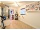 Bright laundry room featuring neutral tile flooring, water heater, and wall shelving at 4785 Ne 28Th Ter, Ocala, FL 34479