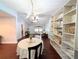 Open-concept living area with vaulted ceiling, featuring a cozy seating area and elegant chandelier at 4785 Ne 28Th Ter, Ocala, FL 34479