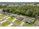 Aerial view of a single-Gathering home with a spacious backyard, landscaping, and mature trees at 5026 Sw 128Th St, Ocala, FL 34473