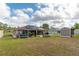 Spacious backyard with a covered patio, above ground pool, fire pit, and a storage shed at 5026 Sw 128Th St, Ocala, FL 34473