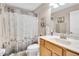 Bathroom featuring a single sink vanity, marble countertop, and shower at 5026 Sw 128Th St, Ocala, FL 34473