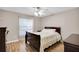 Cozy bedroom featuring hardwood floors, ceiling fan, and neutral paint at 5026 Sw 128Th St, Ocala, FL 34473