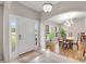 Open foyer featuring tile floors, arched doorways, and a view of the adjacent dining area bathed in natural light at 5026 Sw 128Th St, Ocala, FL 34473