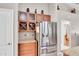 Kitchen featuring stainless steel refrigerator, granite countertops and wine storage at 5026 Sw 128Th St, Ocala, FL 34473