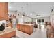 Open concept kitchen with granite island, stainless appliances, and view into the living area at 5026 Sw 128Th St, Ocala, FL 34473