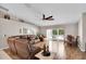 Cozy living room with hardwood floors, large windows, and a view of the outdoor patio at 5026 Sw 128Th St, Ocala, FL 34473