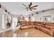 Open-concept living room showcasing a large leather sectional and seamless flow into the kitchen at 5026 Sw 128Th St, Ocala, FL 34473